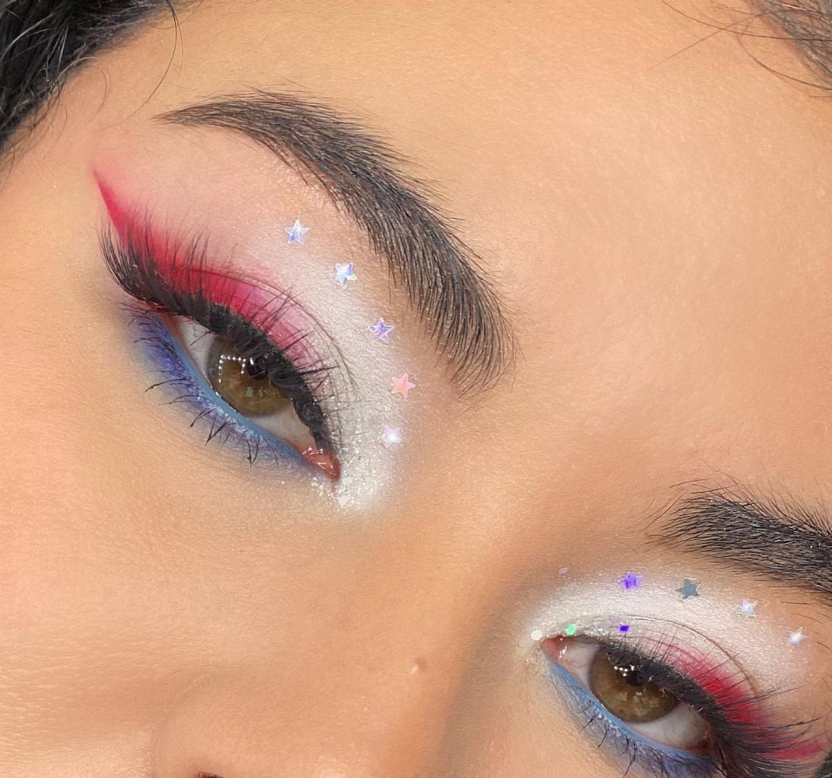 Eyes with red, white, and blue eyeshadow and silver star glitters.