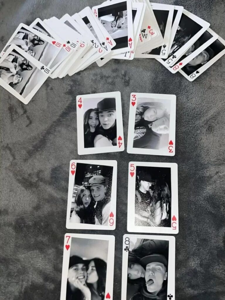 Custom playing cards with black and white photos of a couple on grey fabric
