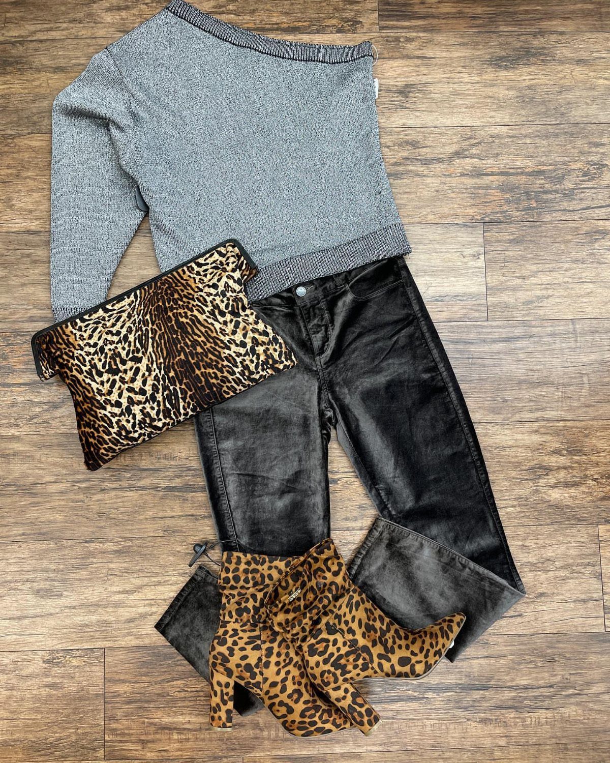 Black velvet pants paired with a grey sweater and leopard print accessories.