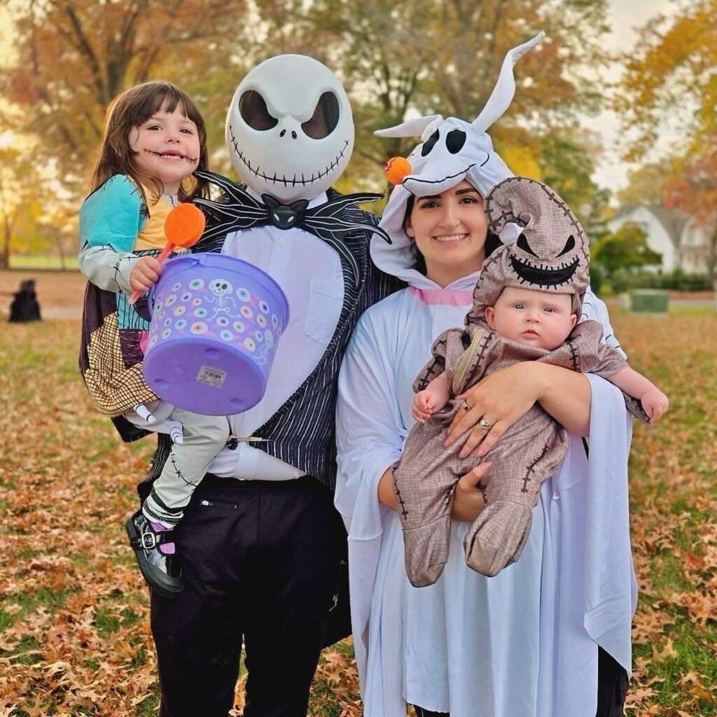 Family dressed as Jack, Sally, and Zero from The Nightmare Before Christmas outdoors.